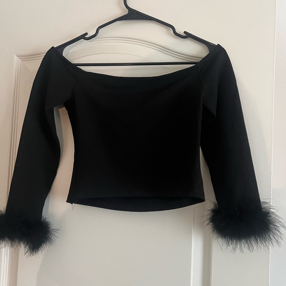 Black 90’s style crop top with feather sleeves and zipper opening